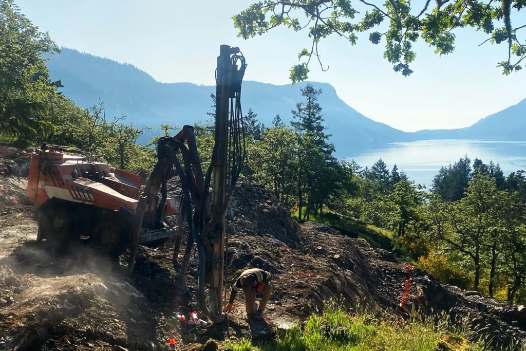 K2 crew at work in the land development stage with the beautiful Maple Bay & mountains in the backdrop